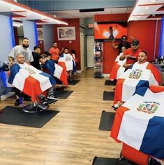 barbers are getting their haircuts done at the same time as others watch