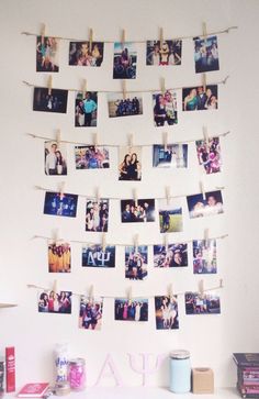 there are many pictures hanging on the clothes line with clothes pins attached to them,