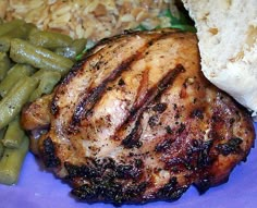 a plate with meat, green beans and rice