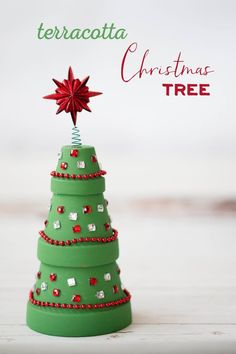 a small green christmas tree sitting on top of a table