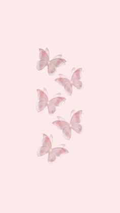 several pink butterflies flying in the air