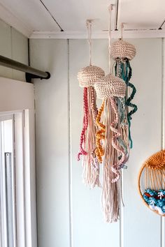 there are many different items hanging from the ceiling in this room and one is made out of yarn