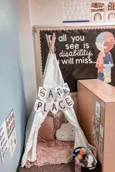 a child's teepee tent with the words safe place on it in front of a chalkboard