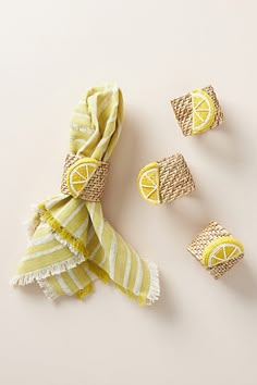 three pieces of yellow and white fabric with lemons on them next to each other