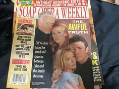 the soap opera magazine is laying on someone's lap