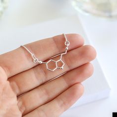 ✨ Sterling Silver Serotonin Bracelet - A Symbol of Happiness & Joy ��✨ This elegant Serotonin Necklace is the perfect gift for someone special who loves science, chemistry, or simply spreading positivity. Featuring the serotonin molecule, this bracelet represents happiness and well-being, making it a meaningful and stylish accessory for everyday wear. Its minimalist design in 925 sterling silver ensures it pairs effortlessly with any casual outfit, adding a touch of personality to their style. Eac Molecule Jewelry, Serotonin Necklace, Bespoke Packaging, Running Necklace, Serotonin Molecule, Soul Sisters Gifts, Science Jewelry, Woman Logo, Bff Necklaces