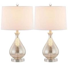 two glass lamps with white shades on each one and a beige shade on the other