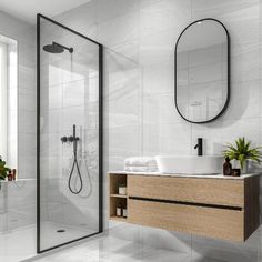 a bathroom with a sink, mirror and shower stall in the middle of the room