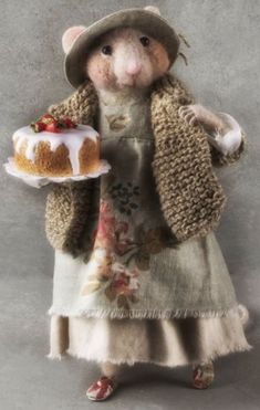 a stuffed mouse holding a bundt cake