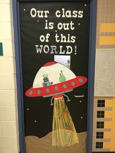 a door decorated with an image of a spaceship and the words our class is out of this world