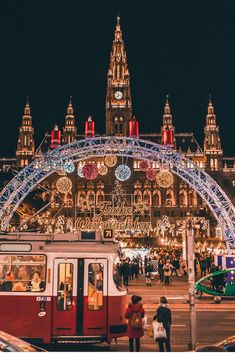 an instagram page with people standing in front of a train and christmas lights on the building