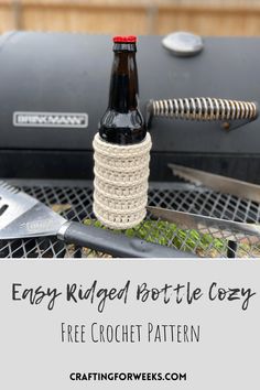 a beer bottle sitting on top of a grill with the words easy rugged bottle cozy free crochet pattern