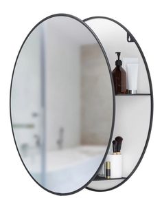 two round mirrors are hanging on the wall