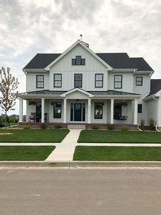 a large white house sitting on the side of a road