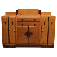 a wooden cabinet with two doors and three drawers