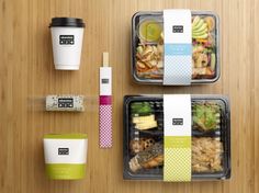 two plastic containers filled with food next to a cup of coffee and some other items