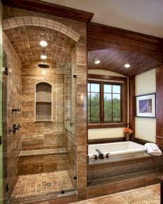 a bathroom with a walk in shower next to a tub