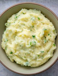 a bowl filled with mashed potatoes on top of a table