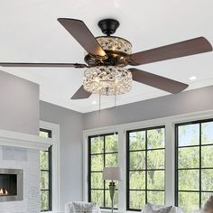 a living room with two couches and a ceiling fan