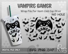 a cup with a game controller on it next to a sticker that says vampire gamer