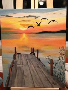 a painting of a sunset with birds flying over the water and a dock in the foreground