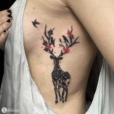 a woman's chest with a deer tattoo on it