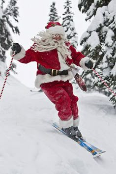 santa claus is skiing down a snowy hill