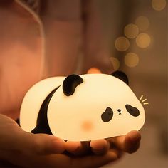 a person holding a small light shaped like a panda bear