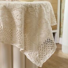 there is a white crocheted table cloth on the radiator