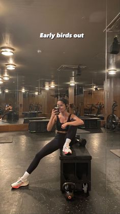 a woman taking a selfie in a gym