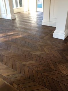 an empty room with wood flooring and white trim on the walls is pictured in this image