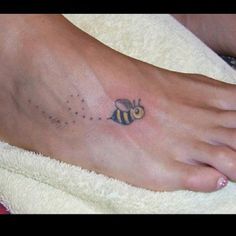 a person with a bee tattoo on their foot