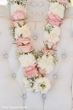 a white chair with pink and white flowers on it