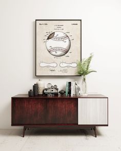 a baseball poster hanging on the wall above a dresser