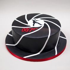 a black and white cake with the number 007 on it's top layer