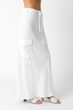 The Kaia White Linen Cargo Maxi Skirt is the perfect vacation cover-up! White linen woven fabric shapes this cargo maxi skirt with a mid-rise fit and drawstring tie. Style with sandals and a cute top and wear to dinner! DETAILS & FIT Loose Fit. 100% Linen. Machine wash cold. Imported. Relaxed Cargo Skirt With Elastic Waistband For Summer, Summer Cargo Skirt With Elastic Waistband And Relaxed Fit, Summer Cargo Skirt With Elastic Waistband, Summer Beach Bottoms With Cargo Pockets, Relaxed Maxi Skirt For The Beach, Relaxed Maxi Length Skirt For Summer, Casual Summer Cargo Skirt With Drawstring, Casual Cargo Skirt With Drawstring For Summer, Casual Drawstring Cargo Skirt For Summer