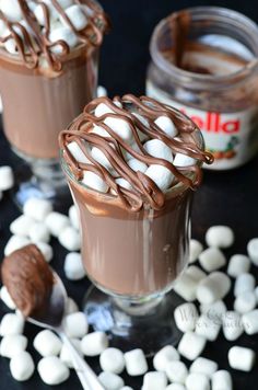 two glasses filled with hot chocolate and marshmallows