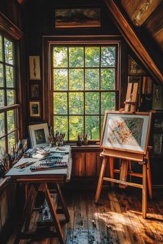 an artist's studio with easel and paintings