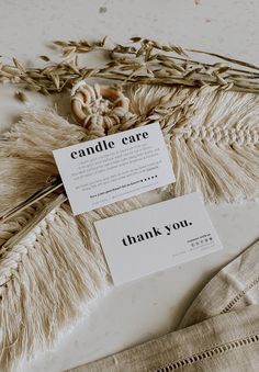 two cards that say, candle care and thank you on top of some dried plants