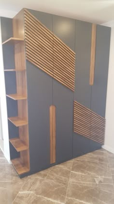 an empty room with some shelves and shelving units on the wall in front of it