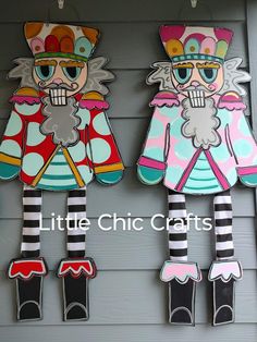 two paper dolls hanging on the side of a building with words little chic crafts