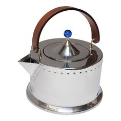 a tea kettle with a wooden handle on it