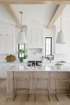 a kitchen with white cabinets and an island in the center is featured on instagram