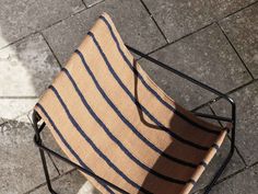 a chair that is sitting on the ground next to a brick floor and some bricks