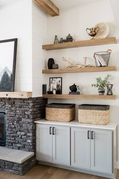 an image of a living room with shelves and baskets on the fireplace mantels