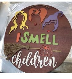 a wooden sign that says i smell children with witches and pumpkins on the front