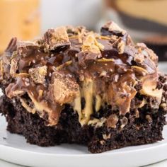 a close up of a piece of cake on a plate with chocolate and peanut butter