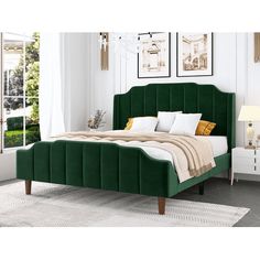 a green bed in a white room with pictures on the wall and carpeted floor