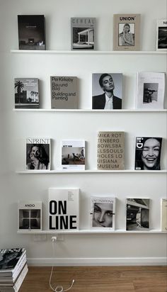 the wall is filled with books and magazines