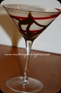 a martini glass sitting on top of a wooden table